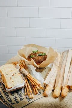 The baker is presenting new bread products to the visitors of the bakery. Stock Photos