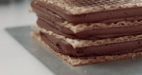 Baker press layers of chocolate cake Stock Footage 77647750