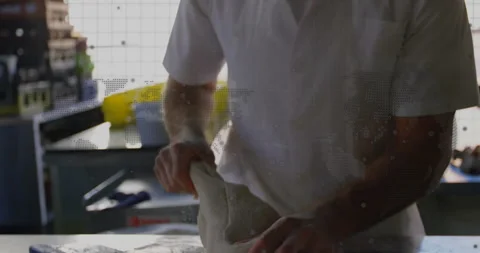 Baker pressing and stretching dough in bakery workspace, showing animated grid Stock Footage 309097233