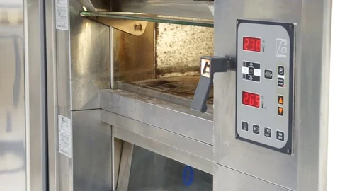 Baker pulling out of the oven a pizza with tomatoes Stock Footage 72718310