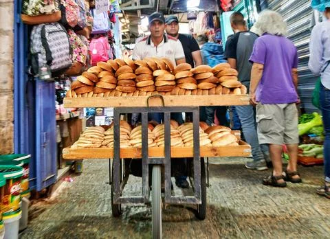 Baker pushes cart of bread through the old city of Jerusalem Stock Photos