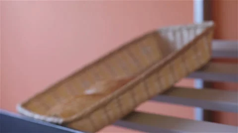 Baker put a basket of braid on shelf (pan shot) Stock Footage 55501863