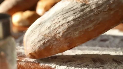 Baker put bread on the table, slow motion Stock Footage 10735047