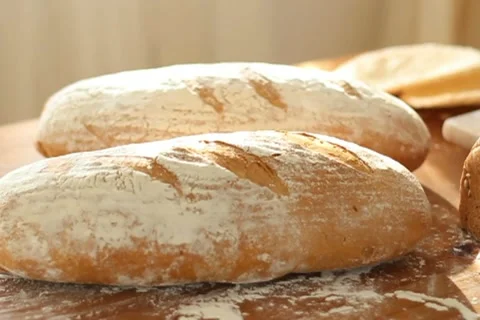 Baker put bread on table, slow motion, dolly shot Stock Footage 10735080