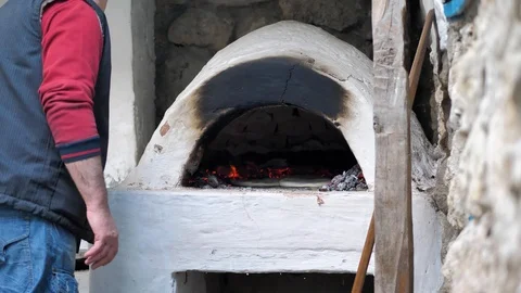 The Baker put the flatbread to bake and closed the iron door of the stove Stock Footage 125523687