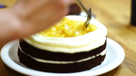 A baker put fruits on top cake. make the cake Video stock 72256777