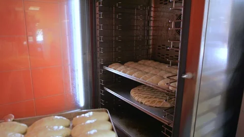 Baker put the pan in the oven Stock Footage 96423699