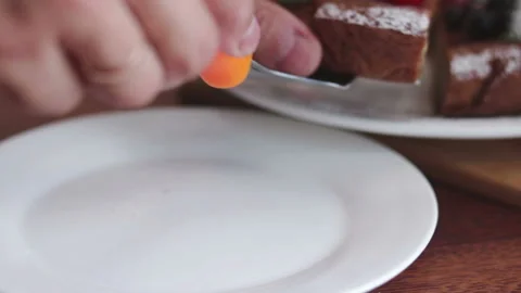 Baker put piece of homemade cake on white plate Stock Footage 102332838