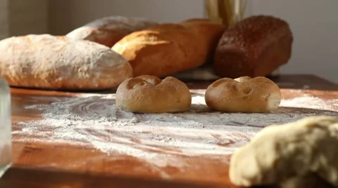 Baker put two buns on the table, tracking shot Stock Footage 10735038