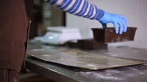 Baker puts the bakeware on a tray and takes away Stock-Footage 106461230