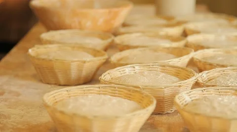 The baker puts a basket of dough on the table Vídeo Stock 49317322