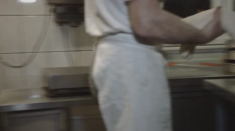 Baker puts Bread into Bakeware Stock Footage 66439317
