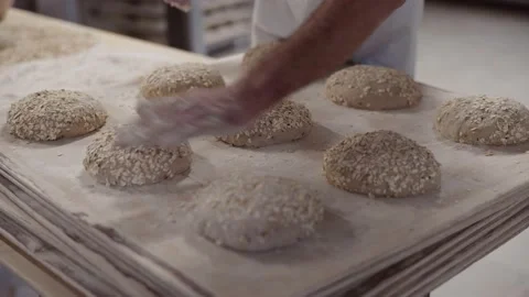 The baker puts the bread in the dough to bake Stock Footage 143980507