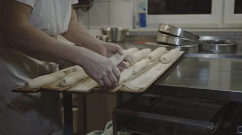 Baker puts Bread on wooden Boards Stock Footage 66442465