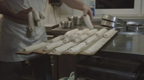 Baker puts Bread on wooden Boards Stock Footage 66442636