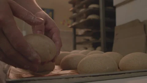 Baker puts buns on a tray Stock Footage 231335100
