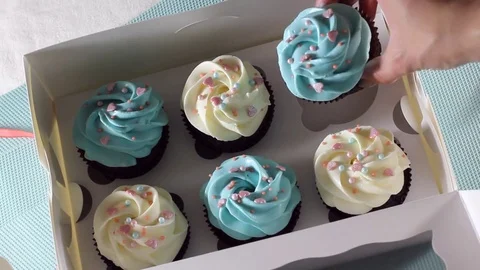 Baker puts cupcakes into the box, beautiful and delicious food, cooking and Stock Footage 77005924