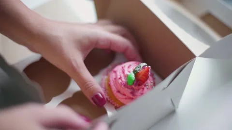 Baker puts cupcakes into the box Stock Footage 143585736