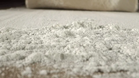 The Baker puts the dough for the pizza on the table. Stock Footage 118135556