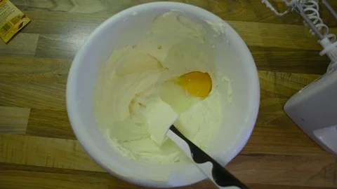 Baker puts eggs into dough Stock-Footage 78564093