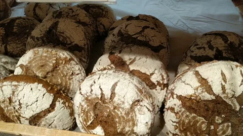 The Baker puts fresh bread on the counter of the store. Medium plan, real time, Stock Footage 130011955