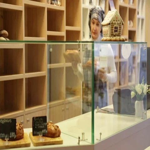 Baker puts pies in the shop window Stock Footage 69484309