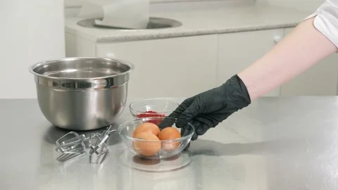 Baker puts tools and ingredients on table to prepare cake Video stock 139487089