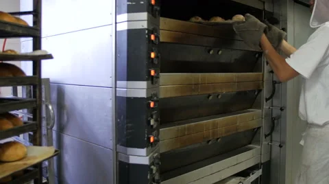 Baker Putting Bread Dough into Oven Stock Footage 51332734