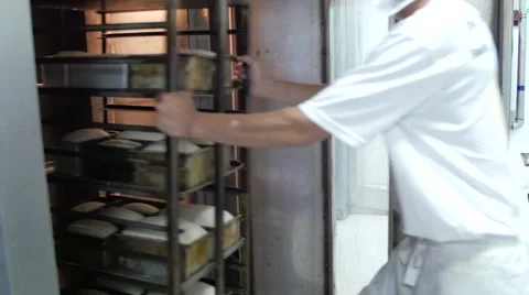 Baker Putting Bread in Oven Stock Footage 51331706