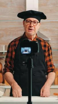 Baker recording video tutorial Stock Photos