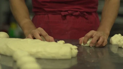 Baker rolling balls of dough in a bakery Stock Footage 128461713