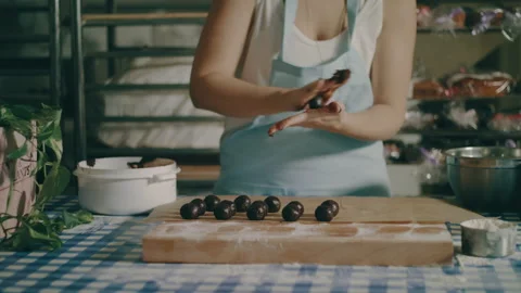 Baker rolling chocolate ball between her hands Stock Footage 274648654