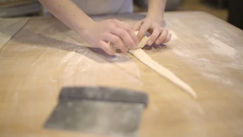 Baker rolling croissant on a table Stock Footage 87612983
