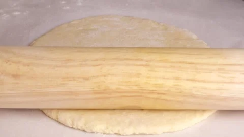 Baker rolling dough with rolling pin in slow motion Stock Footage 305877792