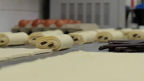 Baker Rolling Pain au Chocolat with Chocolate Sticks Stock Footage 336395359