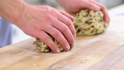 Baker rolling two German Christmas raisins Stollen with his both hands Stock Footage 83279244