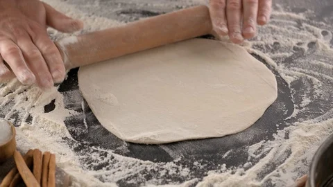 Baker rolls dough with rolling pin Stock Footage 130026577