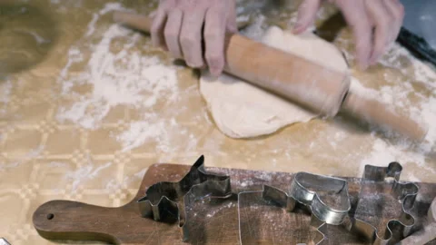 Baker rolls the dough with a rolling pin on the table. Video stock 169161213