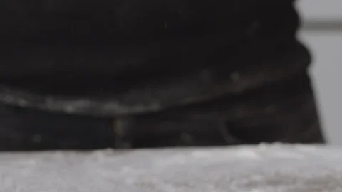 Baker rolls a piece of dough in slow motion. Stock Footage 124878031
