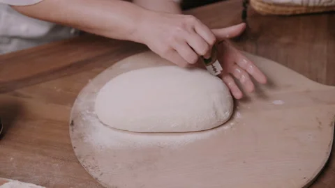 Baker scoring dough with a razor blade Video stock 130394906