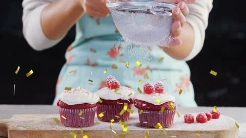 Baker shaking sifter, dusting cupcakes and raspberries with sugar for baking as Video stock 323119160