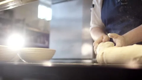 Baker Shaping Bread Dough on Dark Worktop, Artisan Bakery, Backlit Close Up Stock Footage 341339991