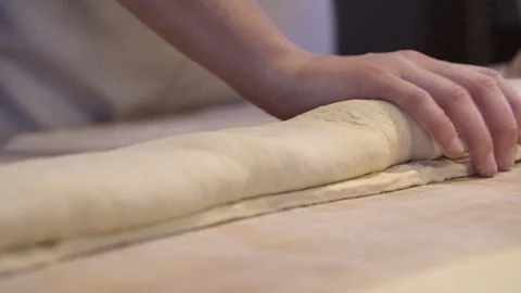 Baker shaping croissant dough on the table Stock Footage 87613074