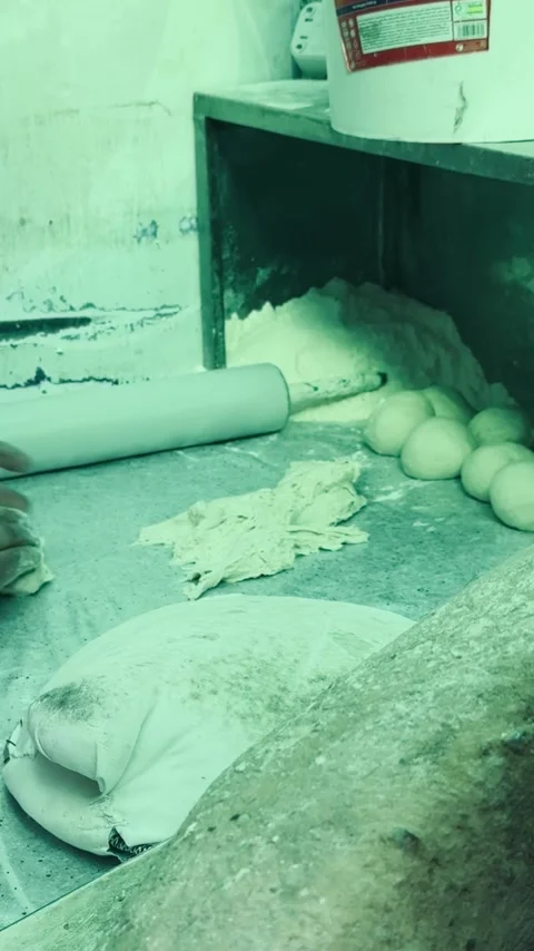 Baker shaping dough balls on bakery table, vertical view Stock Footage 345157375