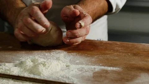 A baker shaping a loaf of bread 4k Stock Footage 86863583