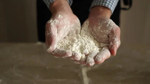 Baker show us a flour in his hands. Stock Footage