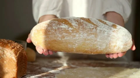 Baker shows fresh-baked bread Stock Footage 10735062