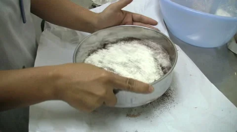 Baker Sifting Cocoa And Icing Sugar 스톡 동영상 1045519