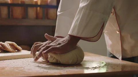 Baker skillfully kneads fresh dough Stock Footage 336232200