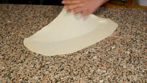 Baker skillfully stretches dough to make a Middle East pastry or stuffed Video stock 98871585